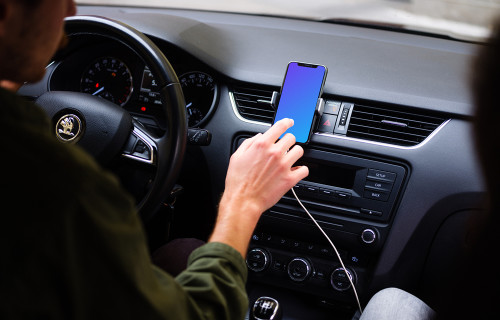 Car driver tapping iPhone 11 mockup in parked car