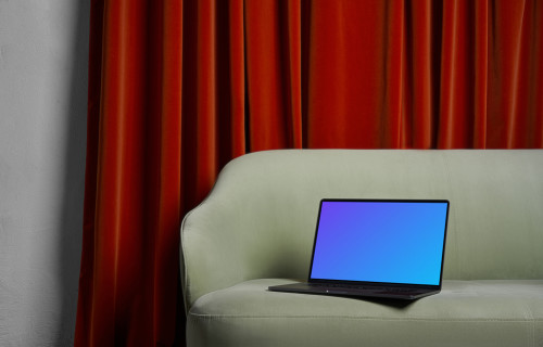 MacBook mockup on a couch with a brown curtain in the background
