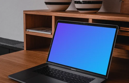 MacBook Pro mockup on a table with pottery above it