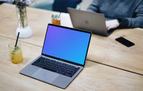 Angle view mockup of Macbook Pro on the wooden table