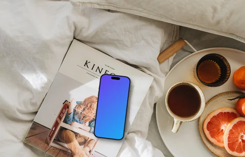 Breakfast in bed spread with an iPhone mockup