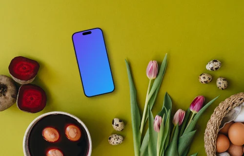 Coloriage d'œufs de Pâques à côté de tulipes et d'un smartphone mockup