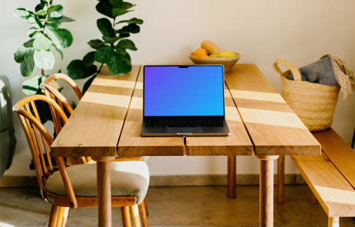 Grey MacBook Pro mockup on a wooden table