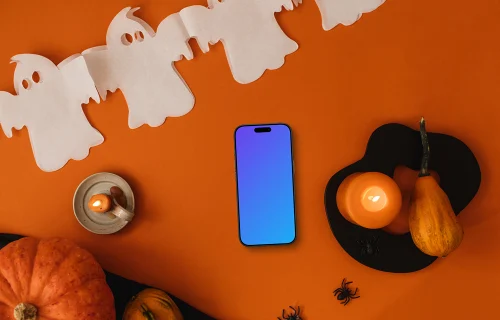 Fondo de Halloween mockup con un teléfono y una calabaza