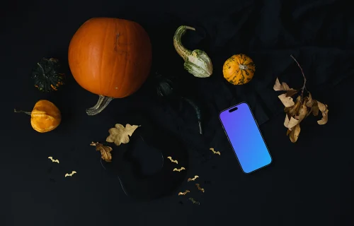 Citrouille d'Halloween mockup avec un smartphone sur fond sombre