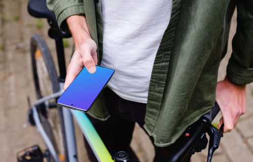 Free Holding Samsung S20 mockup in front of a bike