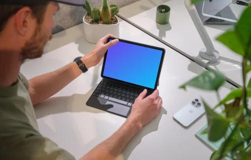 iPad Air mockup in a modern office held by a man