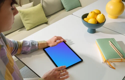 iPad Air Mockup in a Woman's Hand in a Bright Living Room