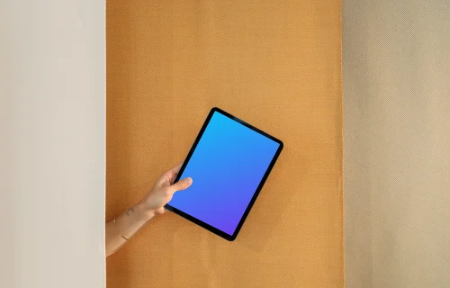 iPad Air mockup with a person holding it against a dual-tone backdrop