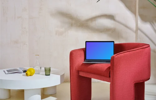 MacBook mockup on a red couch