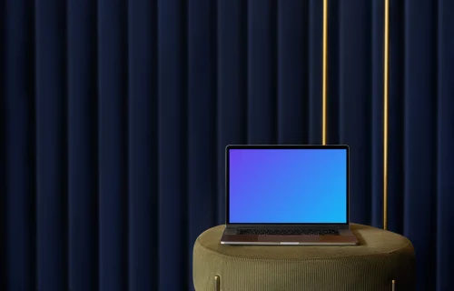 MacBook mockup on a stool with a blue curtain in the background