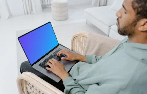 MacBook mockup on a user’s lap