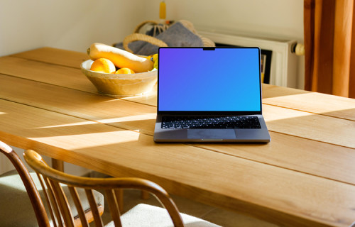 MacBook Pro mockup on a table in front of a fruit basket 