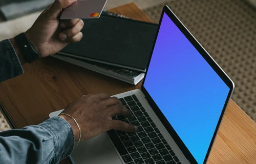 Man entering credit card details on a MacBook Pro mockup