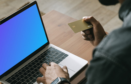 Man making online payment with a Visa card on his MacBook computer mockup.