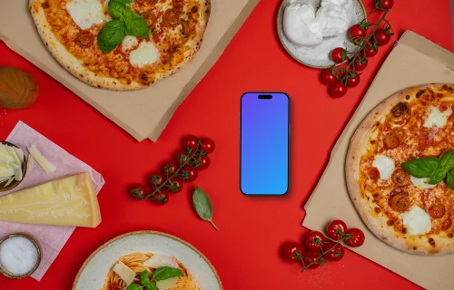 Téléphone mockup entre les cartons de pizza 