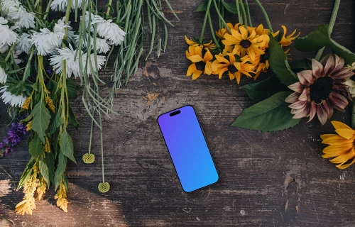 Telefone mockup ao lado de flores