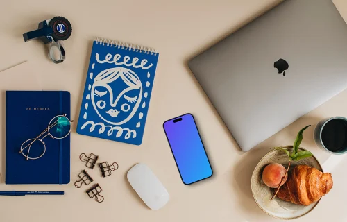 Phone mockup on the desk and laptop on the side