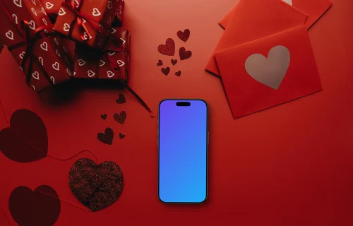 Smartphone mockup en una escena roja con corazones y regalos