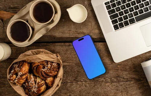 Smartphone mockup next to the coffee and pastries