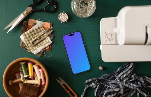 Smartphone mockup next to the sewing machine