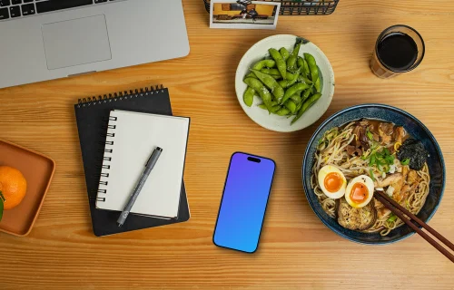 Smartphone mockup on a table with ramen