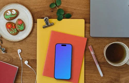 Smartphone mockup on colorful notebooks with Easter gingerbreads