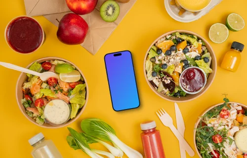 Smartphone mockup surrounded by healthy salads