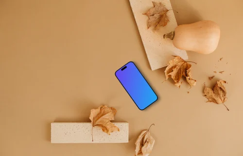 Smartphone mockup entouré de feuilles