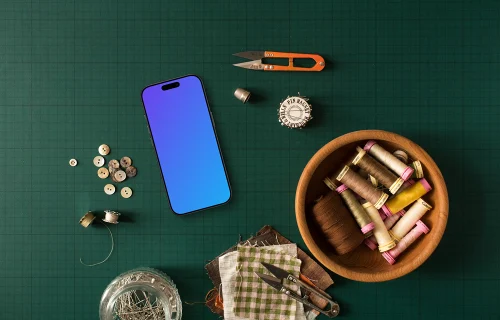 Smartphone mockup surrounded by sewing accessories