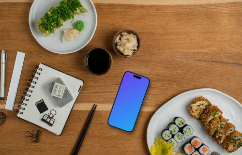 Smartphone mockup entouré de sushis et de décorations