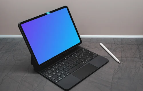 Tablet mockup on a black table with an Apple pencil at the side.