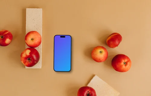 Top view of smartphone mockup next to apples