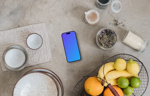 Top view of smartphone mockup next to the basket with fruits