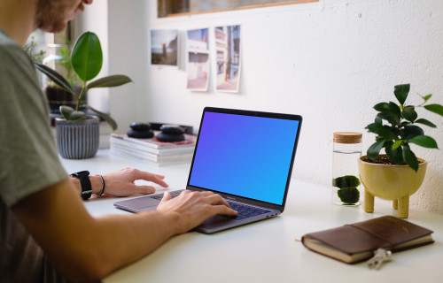 Young man working on the Macbook Pro mockup