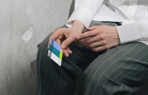 Business card mockup in hand with casual attire