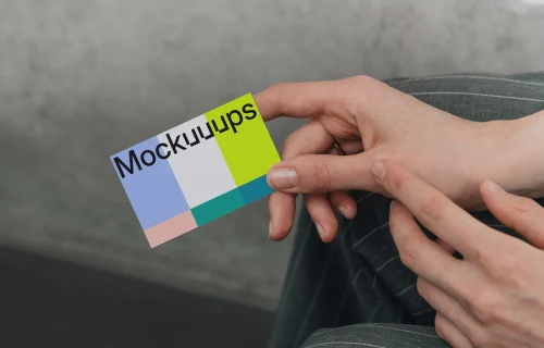 Business card mockup in hands against neutral background