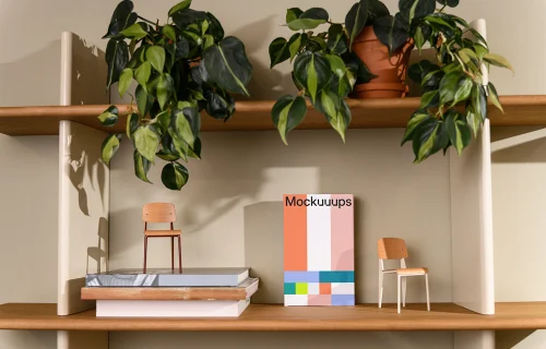 C-format book mockup on a wooden shelf with decor