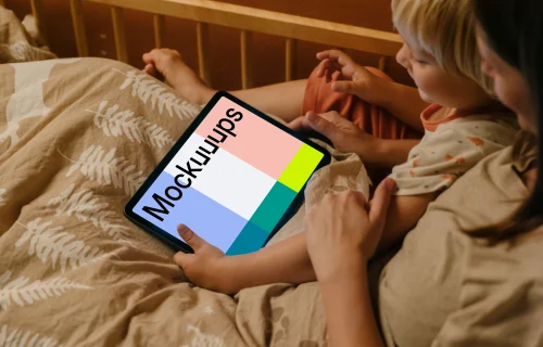 Child's hand holding an iPad Air mockup