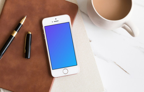 Coffee and iPhone SE mockup placed on marble table