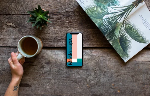 Drinking tea over the iPhone XS mockup and plants