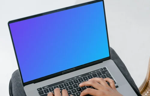 Grey MacBook mockup on a user’s lap