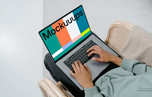 Grey MacBook mockup on user’s laps