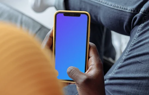 Hand holding iPhone mockup