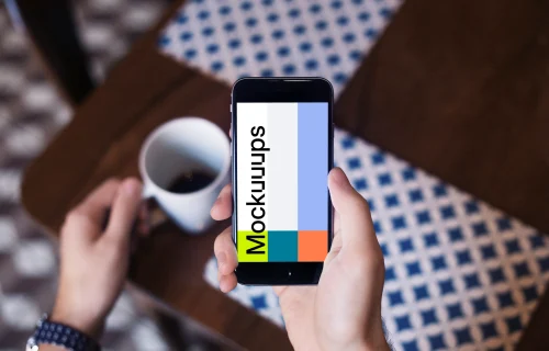 Holding iPhone 6 mockup and drinking coffee