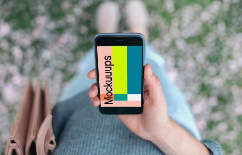 Holding iPhone 6 mockup in city park