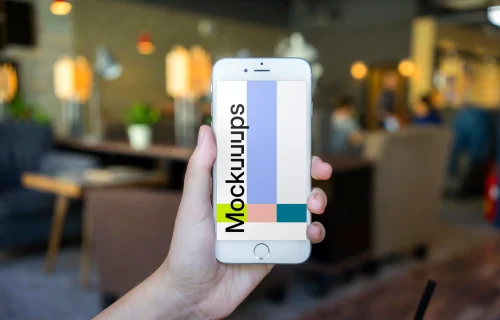 Holding iPhone 6 mockup in shop