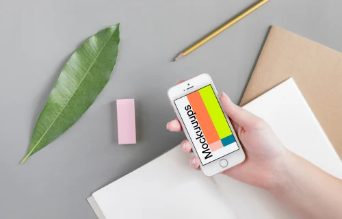 Holding iPhone SE mockup over the journal