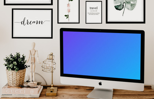 iMac mockup on a table with artwork in the background