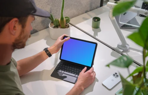iPad Air mockup in a modern office held by a man